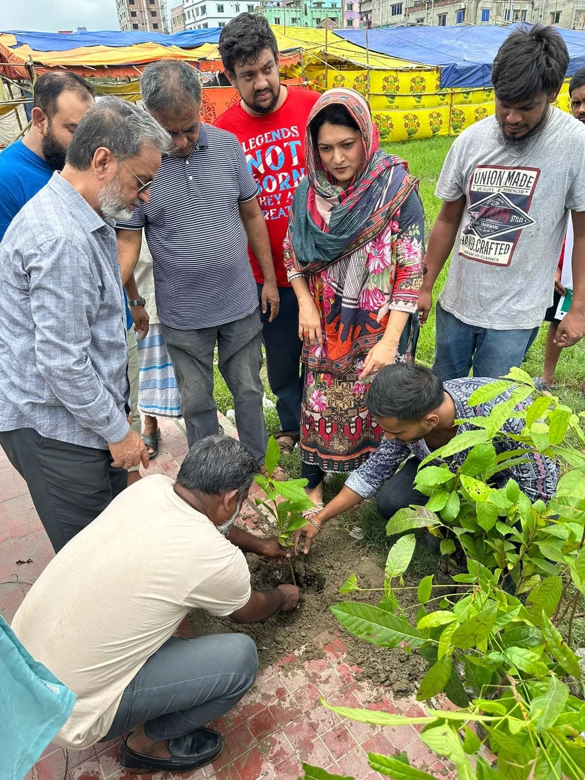People planting a sapling