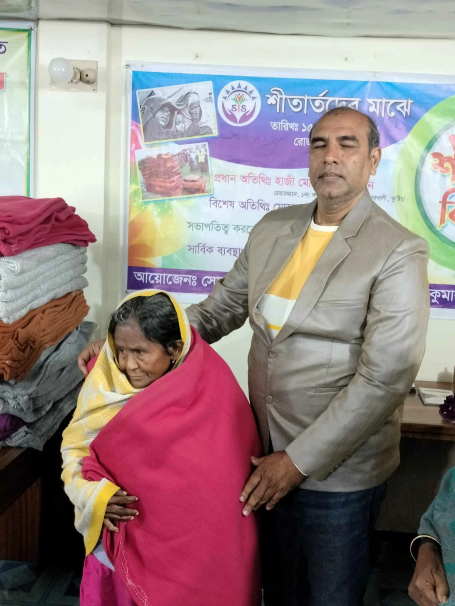 A woman with a blanket at an indoor event