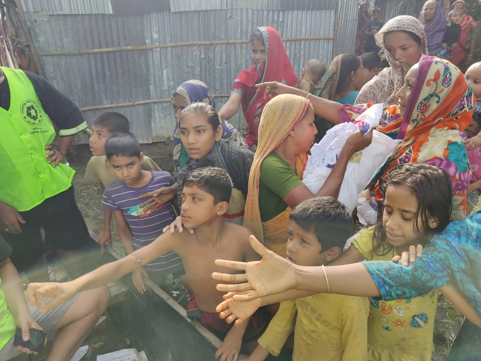 Families gathered around a distribution point