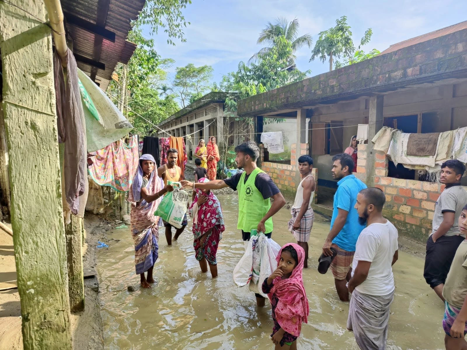 People walking through a waterlogged area